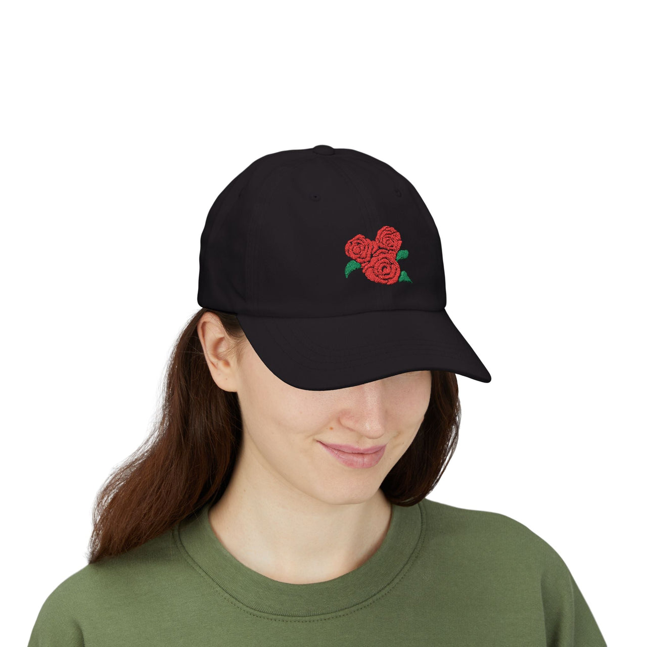 Person wearing a black ball cap with red roses embroidered on it.