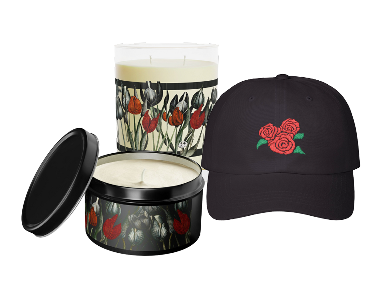 Two candles and one black ball cap. The candles both feature the gothic floral design and the ball cap has red roses and green leaves embroidered on it.