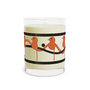The Dream Bird Candle by Printify showcases a decorative design with orange birds on black lines, enveloping cream-colored soy wax in a clear glass holder. Its perfect for aromatherapy sessions and offers a unique blood orange scent with a 65-hour burn time.