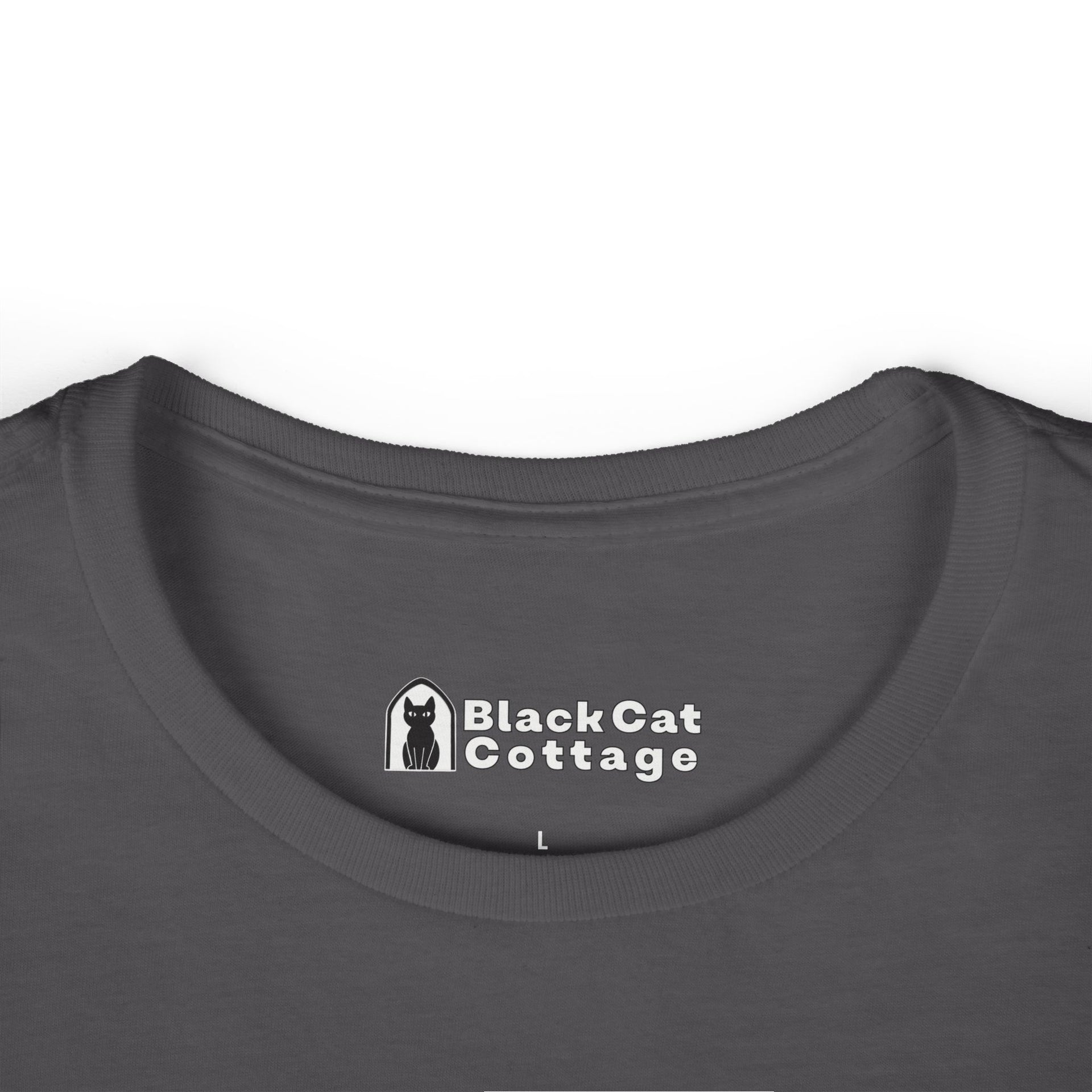 Close-up of a dark gray FAFO Gritty IYKYK Women's T shirt collar by Printify, featuring a printed Black Cat Cottage label and black cat icon with an "L" for size—ideal for anyone seeking a comfy, casual tee.