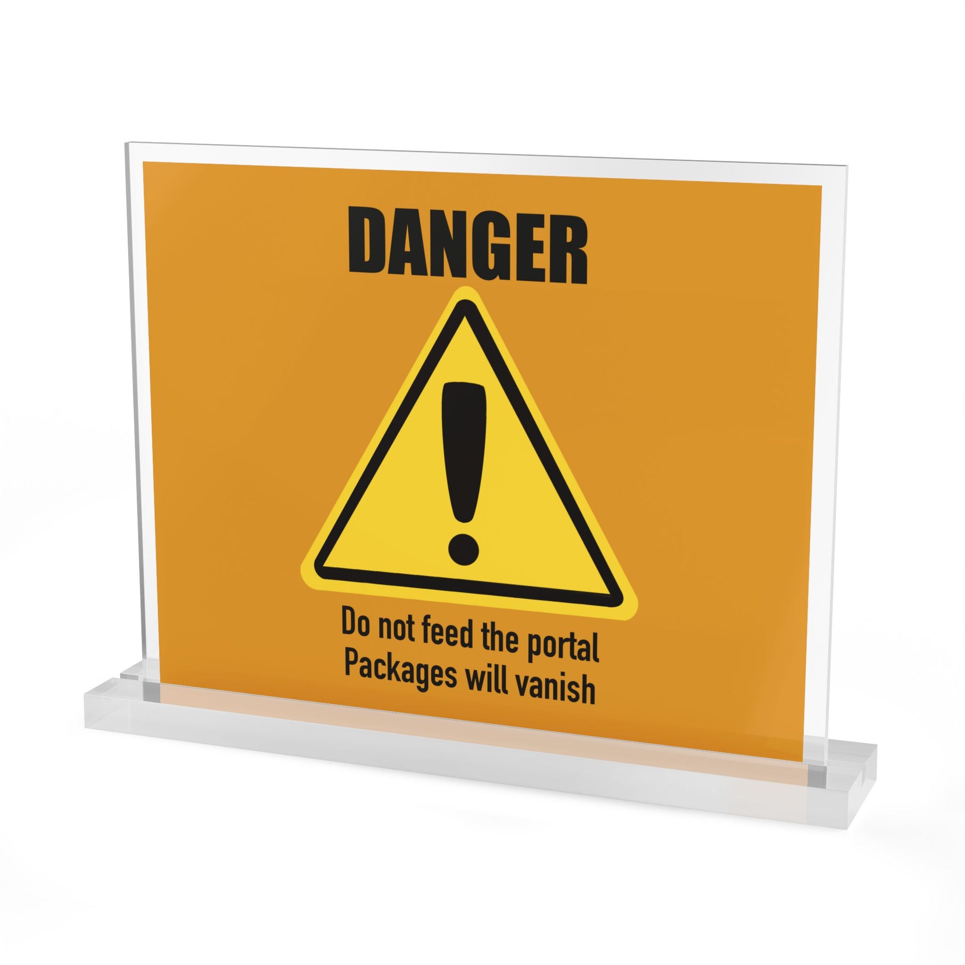 The Printify "DANGER: Do not feed the portal. Packages will vanish" acrylic sign features bold orange text and a warning triangle. Displayed in a clear stand, it’s a customizable, unique package delivery sign for your desk or entryway.